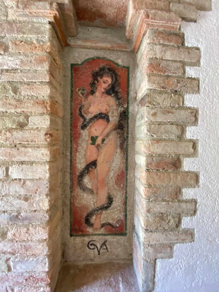 Roman art of a woman with a snake coiled around her.