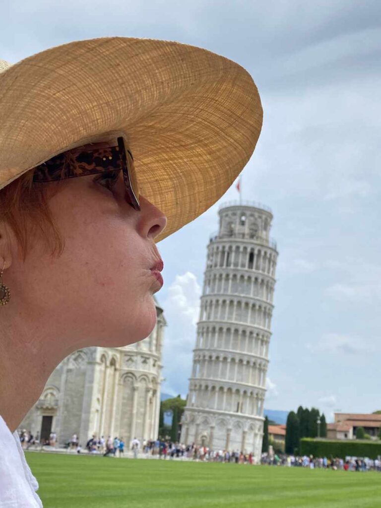 Pat pretending to blow down the leaning tower of pisa.