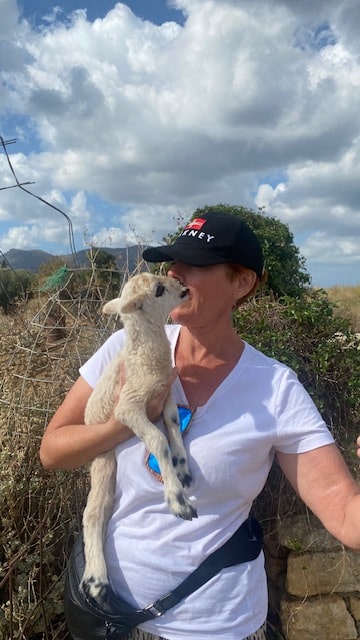 Pat holding the baby lamb.
