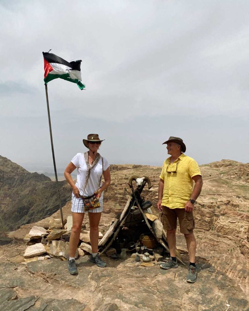 Pat and Glenn beside the monastery flag.