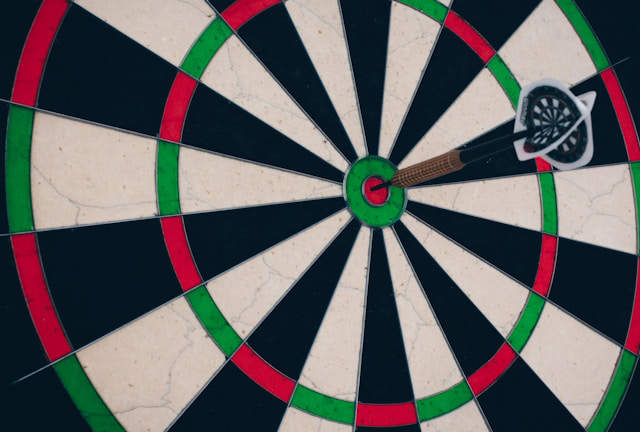 A dart hitting the center of a target.